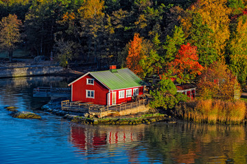 Fototapeta na wymiar Red house on rocky shore of Ruissalo island, Finland