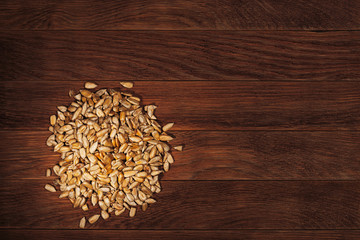 pile of sunflower seeds on old wooden background