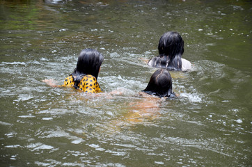 Laotian three girl people play and swimming in stream of Tad Yea