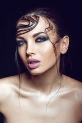 Naklejka premium beautiful girl with wet hair and perfect evening makeup on the black background