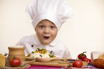 boy chef prepares rice with vegetables