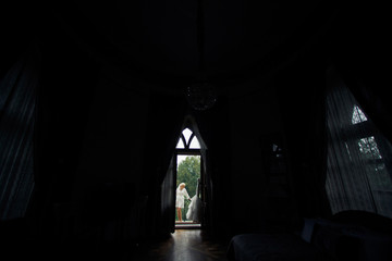 Bride in the robe on the hotel's balcony