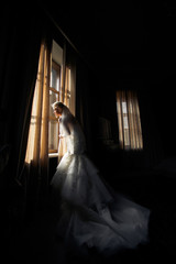Bride in the dress with the long train in the hotel
