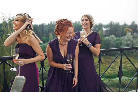 Joyful bridesmaids are drinking champagne