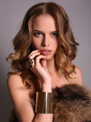 sensual woman with blond curly hair  in elegant gold dress