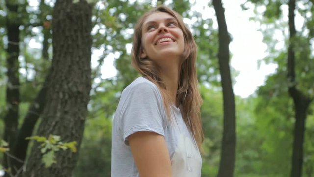 young, beautiful woman enjoying the fresh air in the forest
