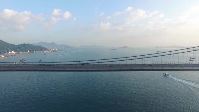 An aerial view fly over Tsing Ma Bridge under sunny day
