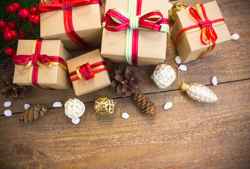 Christmas or New Year background: fur-tree branches, colorful glass balls, decoration and glittering stars on wood background