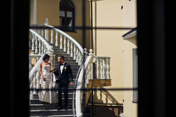 The lovely couple in love stand on the stairs