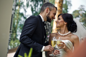 The brides keep a glass of champagne