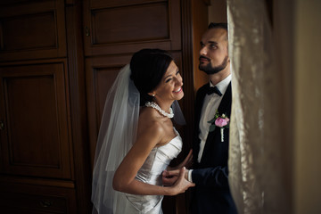 The lovely brides hold hands in the room