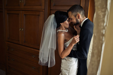 The lovely brides embracing  in the room