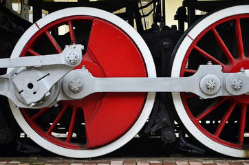 Red wheels of old black USSR steam locomotive