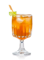 Orange alcohol cocktail with green garnish isolated