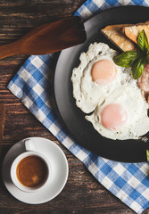 A delicious home style breakfast with crispy bacon, eggs, toast,