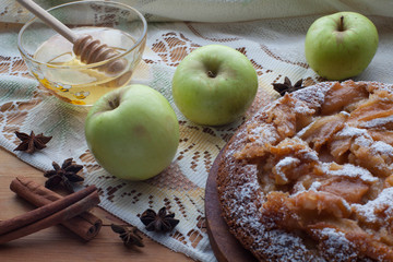 Apple pie - Charlotte on the tablecloth on wooden background