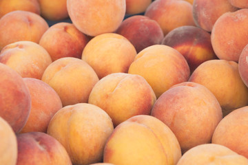 View close-up of fresh peaches. Juicy peaches. A lot of peaches. Heap of peaches. Summer tray market agriculture farm full organic peaches. Fruit peaches background (selective focus)
