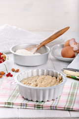 Raw batter for almond cake and ingredients for baking