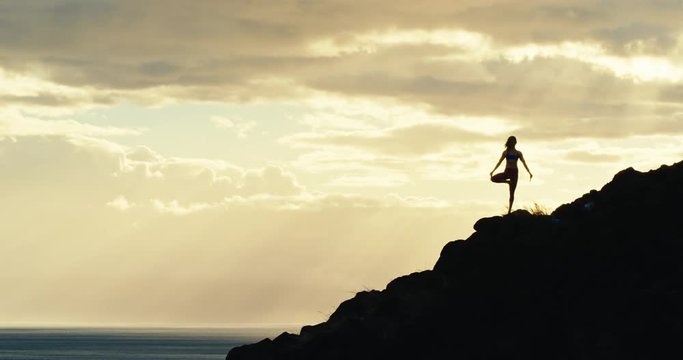 Woman practicing yoga in nature in slow motion