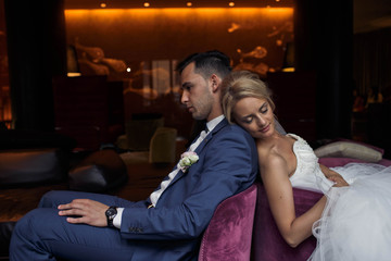 lovely bride  and her husband  sits in hotel