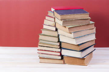 Stack of hardback books on wooden table. Back to school. Copy space