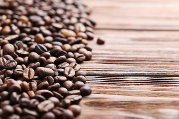 Roasted coffee beans on a brown wooden table