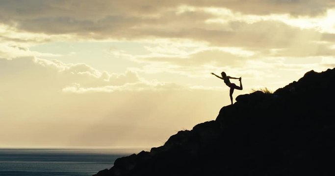 Yoga silhouette of young woman in dancer pose