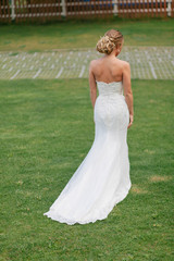 Fototapeta na wymiar Bride in the beautiful dress and nice hairstyle
