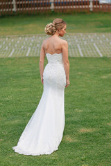 Fototapeta na wymiar Blonde bride in the gorgeous wedding dress