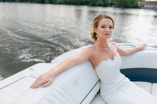 Charming bride is resting on the boat