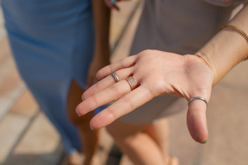 Hand of the bridesmaid with the golden rings