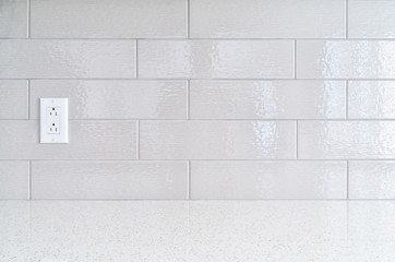 Modern kitchen granite countertop  against gray ceramic backspla
