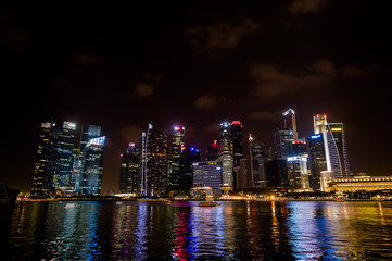 Fototapeta na wymiar Singapore night lights shimmer on the banks of different colors