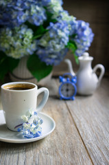 Obraz na płótnie Canvas Blue hydrangea flowers and coffee