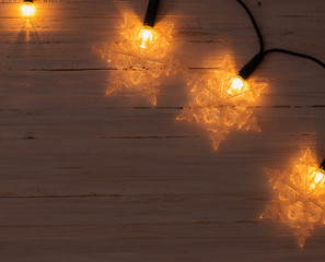 christmas lights on wooden background