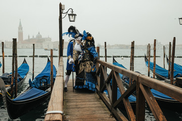 Naklejka na ściany i meble Couple in blue French carnival costumes lean to each other on th