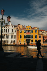 Fototapeta na wymiar A silhouette of a man waiting on the berth in Venice