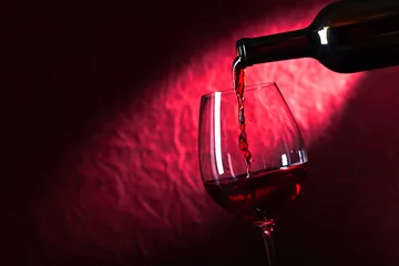 Fotobehang Bottle and glass of red wine on a dark  background © Igor Normann
