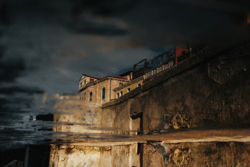Fototapeta premium A blurred picture of the old buildings reflecting in the water
