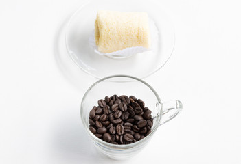 Dark coffee beans with soft roll cake.