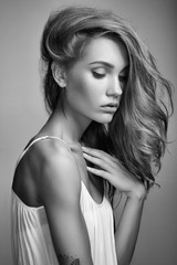 Portrait of young beautiful girl with blonde hair. Fashion photo Hairstyle. Make up. Vogue Style. Black and white photo