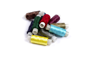 Fototapeta na wymiar Spools of multicolored silk threads on white background