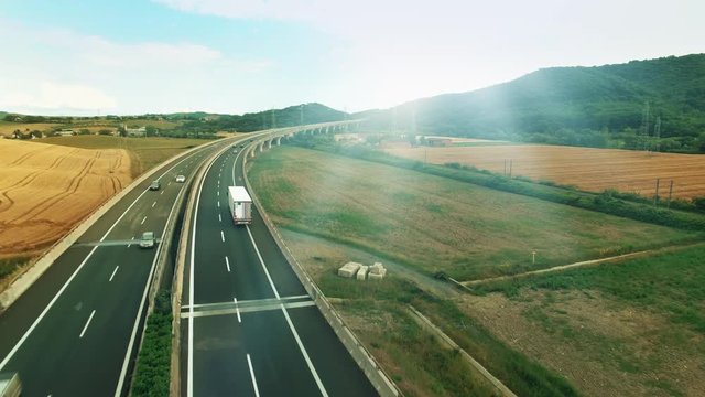 Aerial Shot of Truck on Highway in Rural Area in Sunset Light