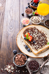 Dutch breakfast, slice of bread with hagelslag chocolate sprinkles and berries. Copy space.