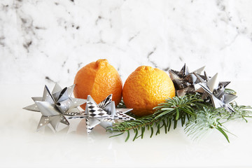 fir branch with clementines and paper stars