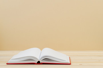Open book, stack of hardback book on wooden table. Back to school. Copy space. Top view