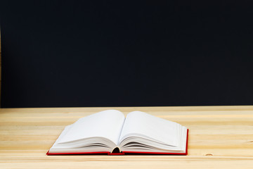 Open book, stack of hardback book on wooden table. Back to school. Copy space. Top view