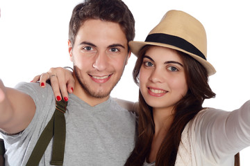 Young beautiful couple on a trip and taking selfie.