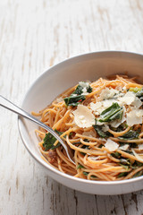 Kale, Tomato and Parmesan pasta dish macro shot