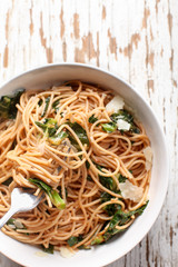 Kale, Tomato and Parmesan pasta dish top view vertical